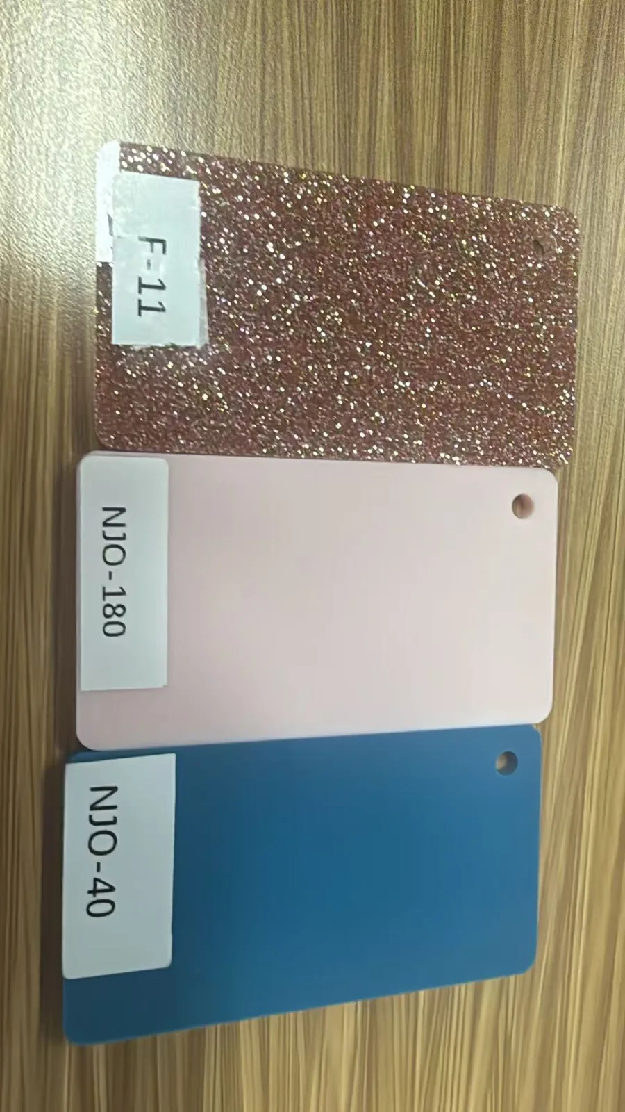 Stacked rose gold glitter, pale pink and lake blue acrylic swatches