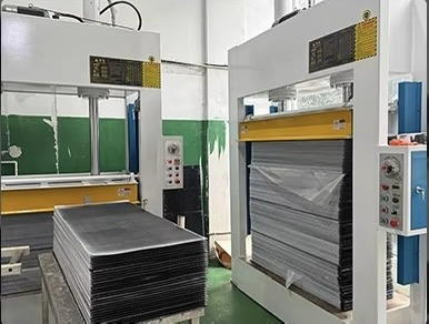 Hydraulic press machines and material stacks in Shenzhen manufacturing facility
